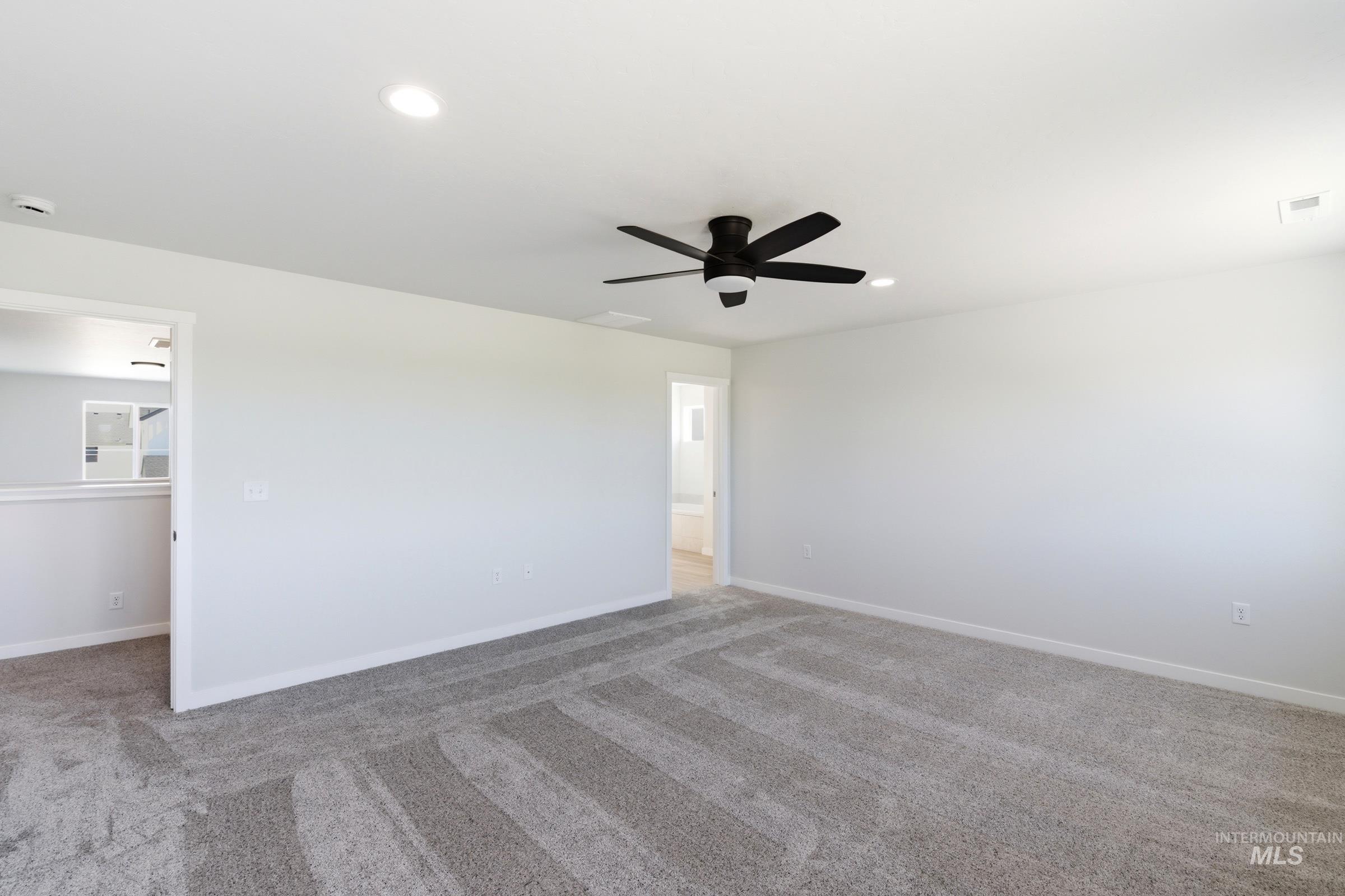 13677 Redway Court Caldwell, ID 83607 - Photo 19 of 35 Spacious room featuring light gray walls, recessed lighting, and a modern ceiling fan