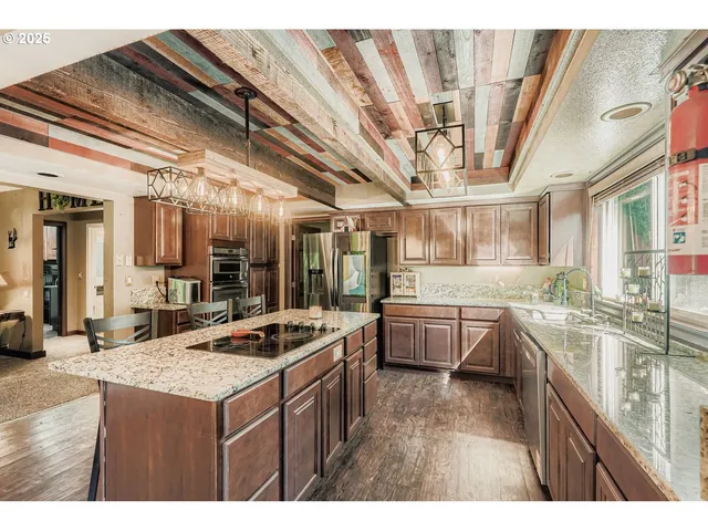 a kitchen with stainless steel appliances granite countertop a sink and cabinets