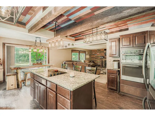 a kitchen with a stove a refrigerator and a table