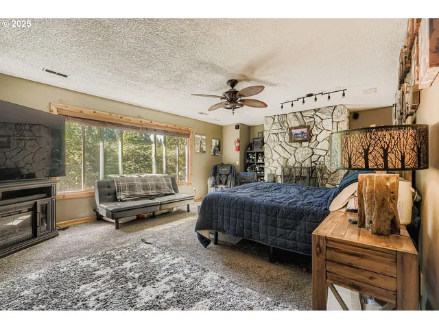 a bedroom with a bed and large window