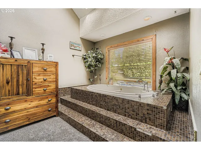 a spacious bedroom with a bed and a window