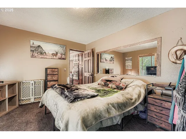 a bedroom with a bed a couch and dresser