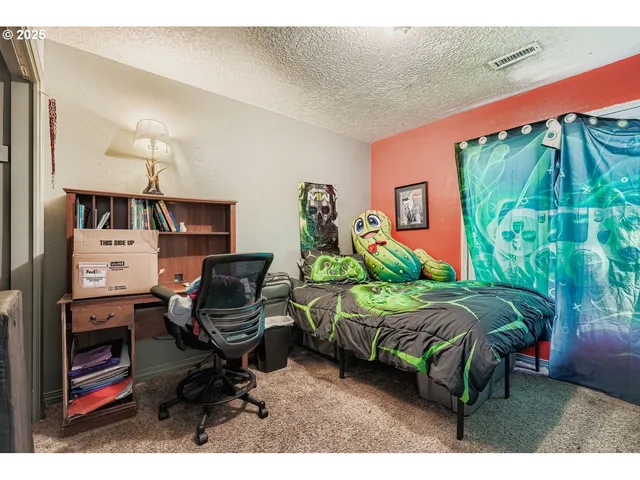 a bedroom with a bed and a bookshelf