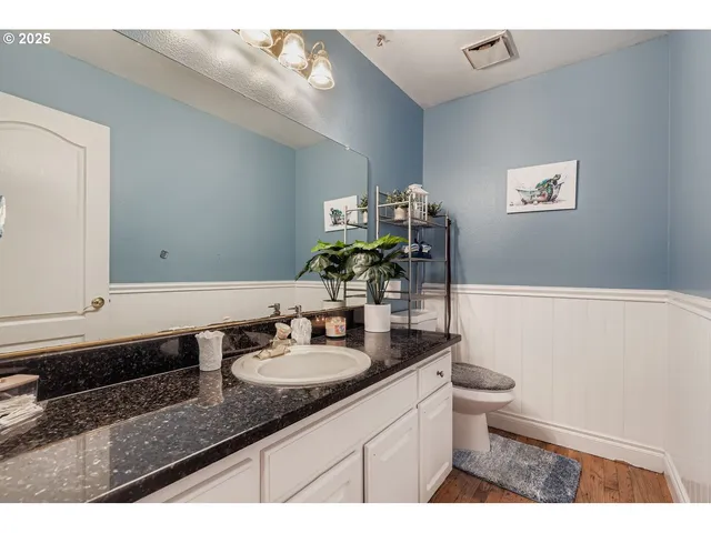 a bathroom with a sink a vanity and a mirror