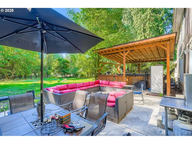 a wooden bench sitting in front of a yard