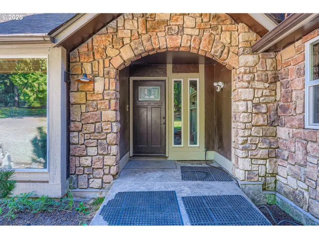 a view of a brick house with a large window