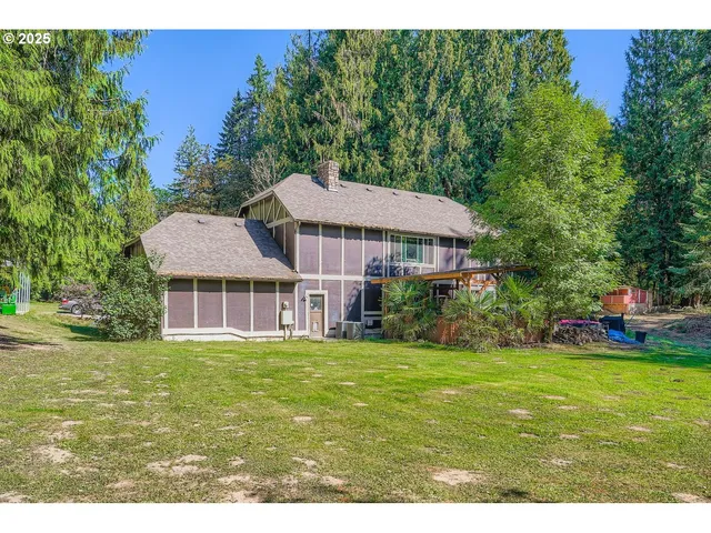 a view of a house with a yard and sitting area