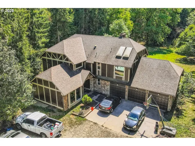 an aerial view of a house with swimming pool and furniture