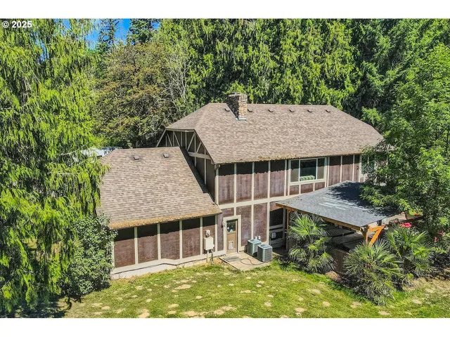 a aerial view of a house with a yard table and chairs