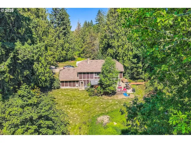 a view of a house with a yard and tree s