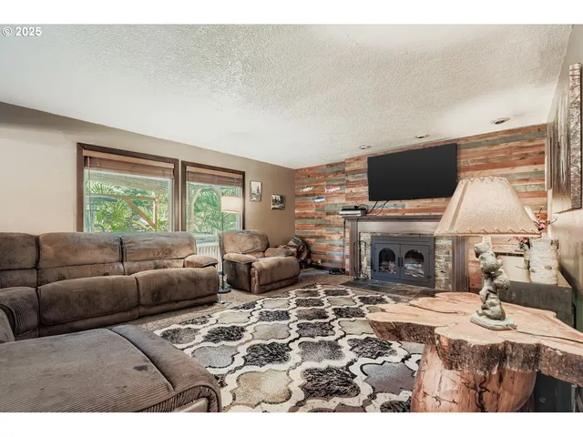 a living room with furniture a fireplace and a flat screen tv