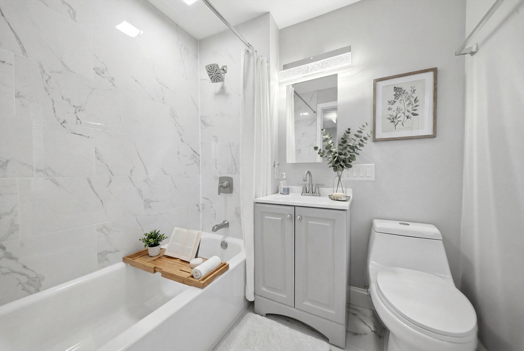 7 Pine Street Stoneham, MA 02180 - Photo 11 of 23 a bathroom with a sink a toilet and shower
