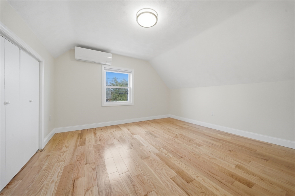 7 Pine Street Stoneham, MA 02180 - Photo 12 of 23 an empty room with wooden floor and windows