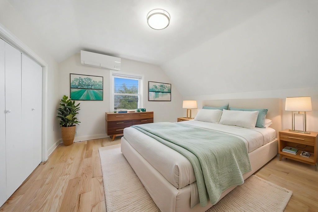 7 Pine Street Stoneham, MA 02180 - Photo 13 of 23 a bedroom with a large bed and a potted plant