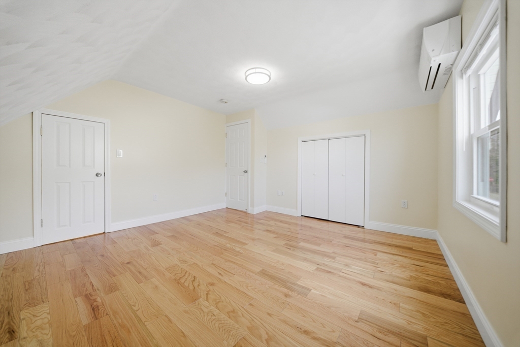 7 Pine Street Stoneham, MA 02180 - Photo 14 of 23 a view of an empty room with wooden floor and a window