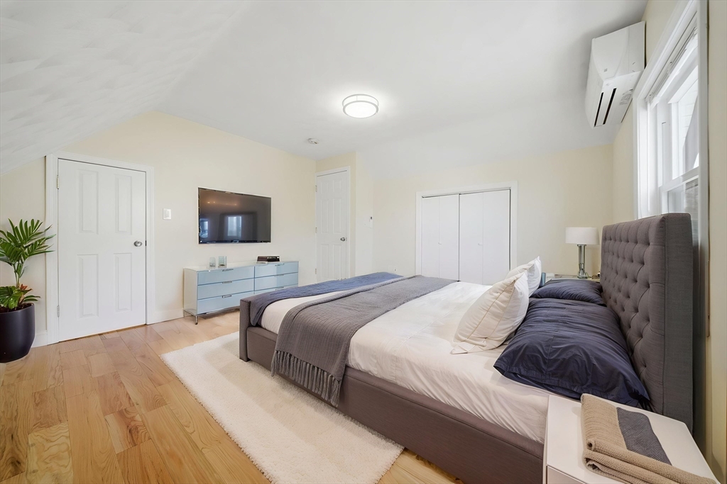 7 Pine Street Stoneham, MA 02180 - Photo 15 of 23 a bedroom with a bed and a flat screen tv