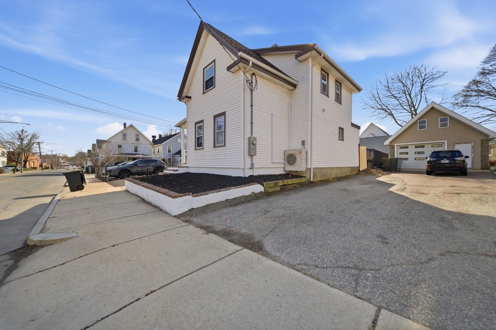 7 Pine Street Stoneham, MA 02180 - Photo 2 of 23 a view of a white house with a yard
