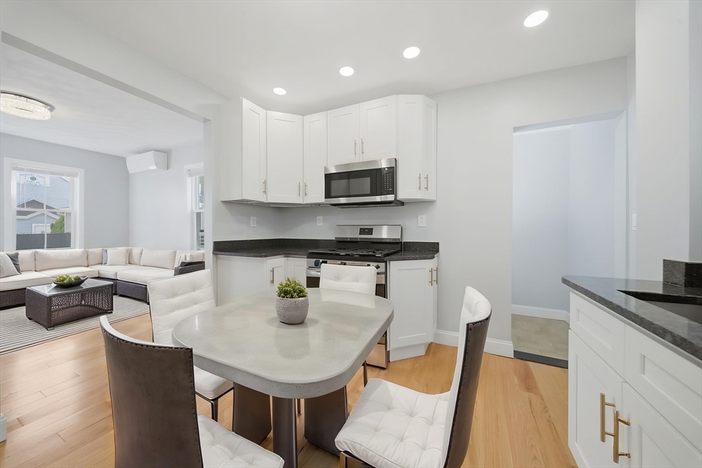 7 Pine Street Stoneham, MA 02180 - Photo 5 of 23 a kitchen with a sink a stove and chairs