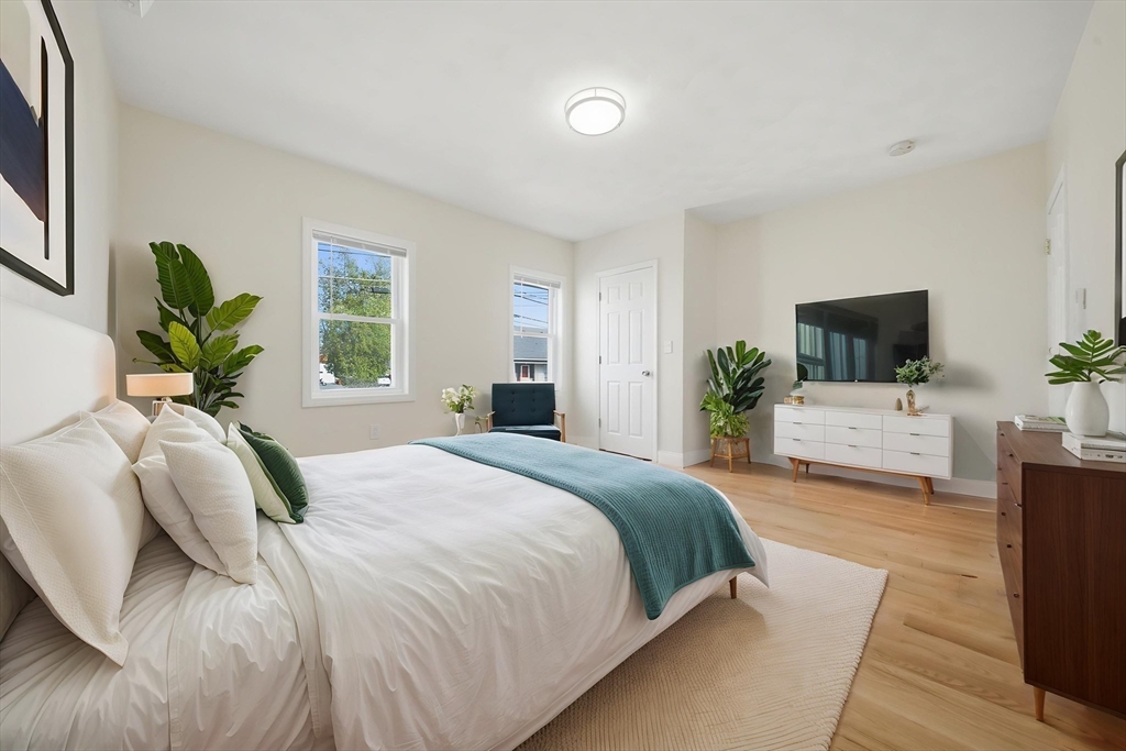 7 Pine Street Stoneham, MA 02180 - Photo 7 of 23 a bedroom with a large bed and a flat screen tv