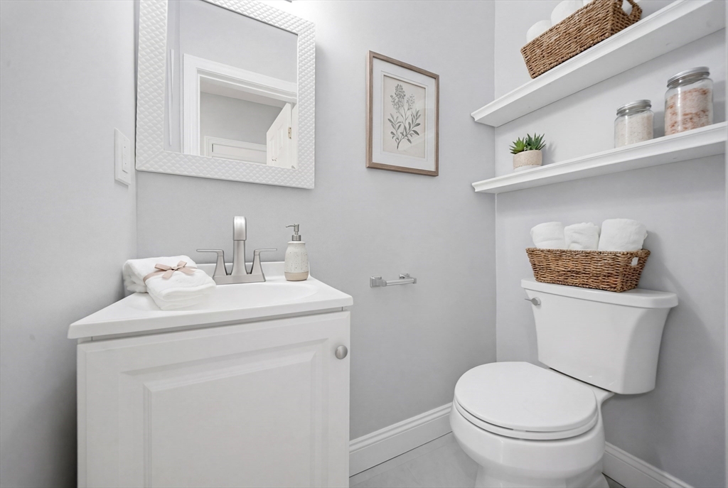 7 Pine Street Stoneham, MA 02180 - Photo 8 of 23 a bathroom with a toilet sink and mirror