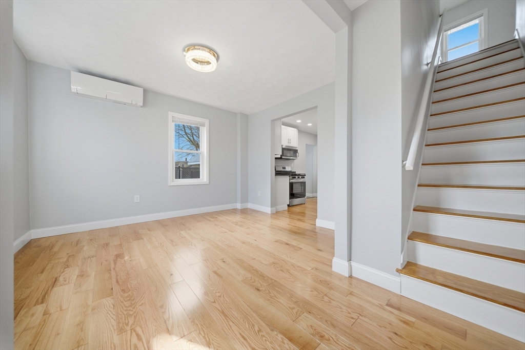 7 Pine Street Stoneham, MA 02180 - Photo 9 of 23 a view of an empty room with wooden floor and a window