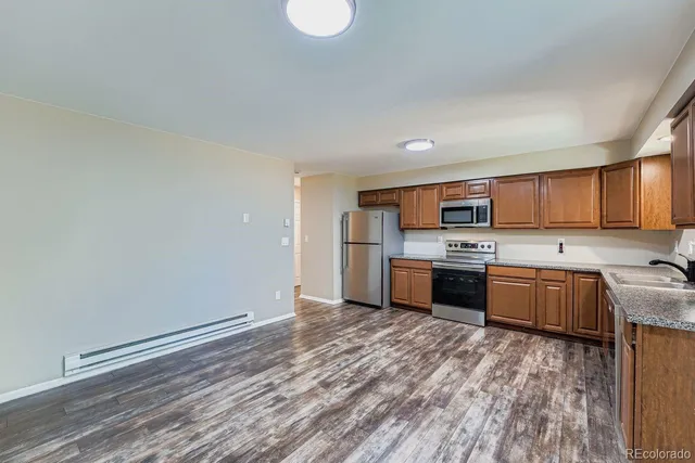 a kitchen with stainless steel appliances a refrigerator and a sink