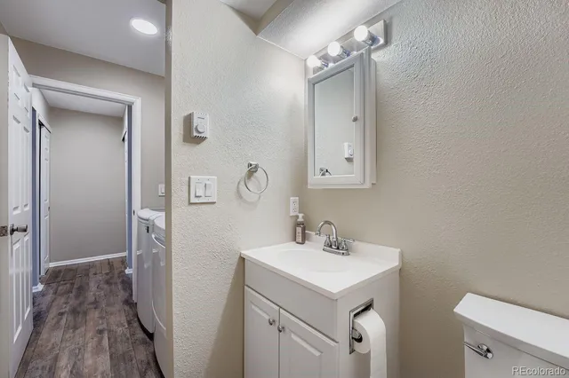 a bathroom with a sink a toilet a shower and a mirror