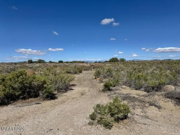 a view of a mountain with a yard
