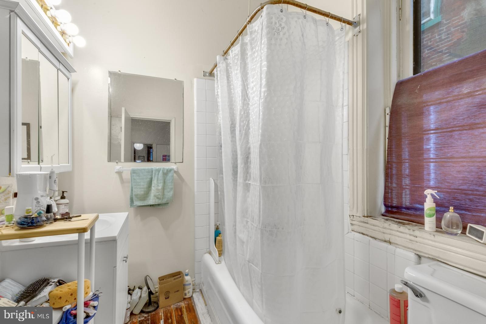 4713 Baltimore Avenue, Unit 1 Philadelphia, PA 19143 - Photo 11 of 22 a bathroom with a sink and a mirror