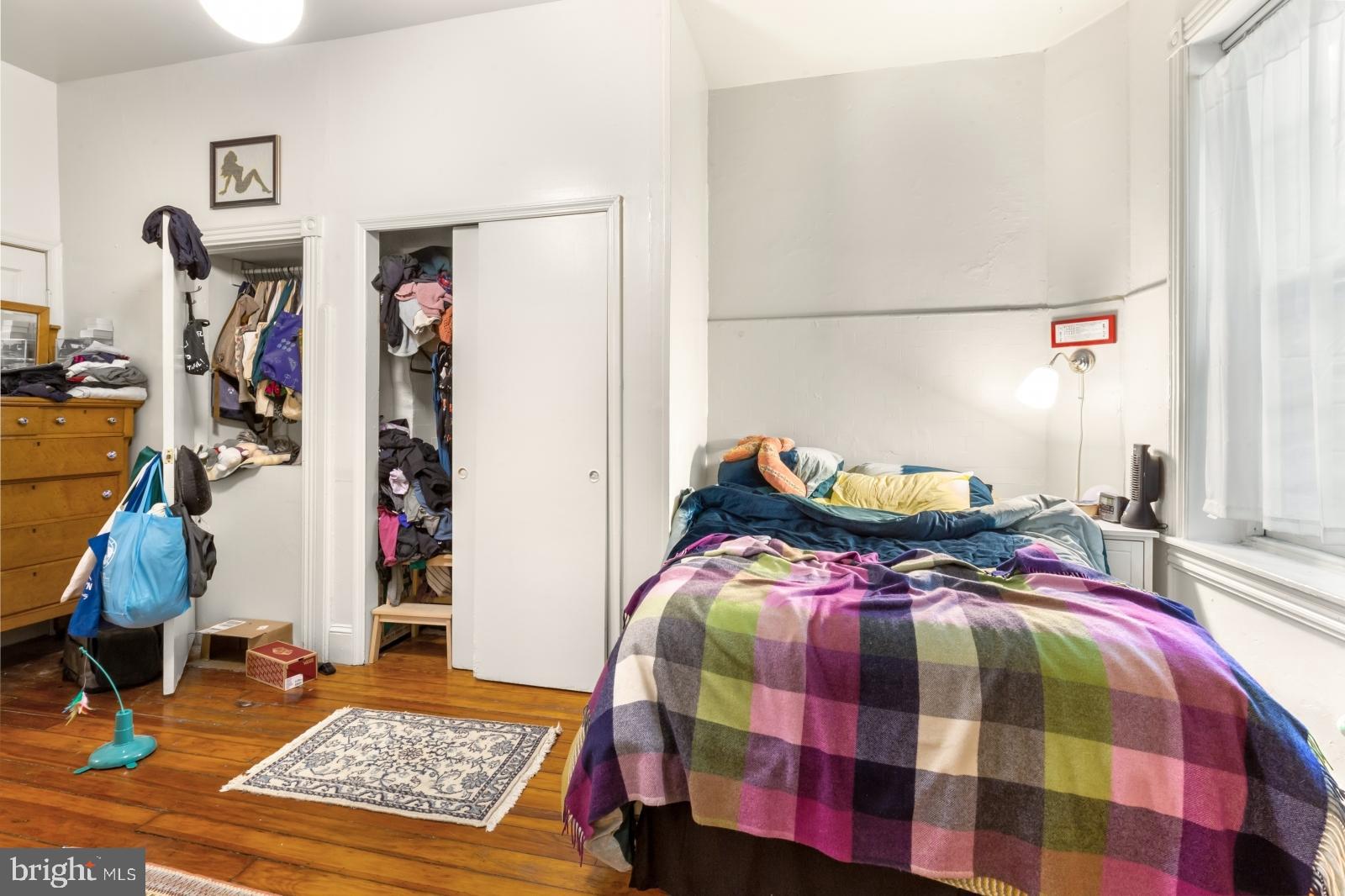 4713 Baltimore Avenue, Unit 1 Philadelphia, PA 19143 - Photo 13 of 22 a bed sitting in a bedroom next to a window