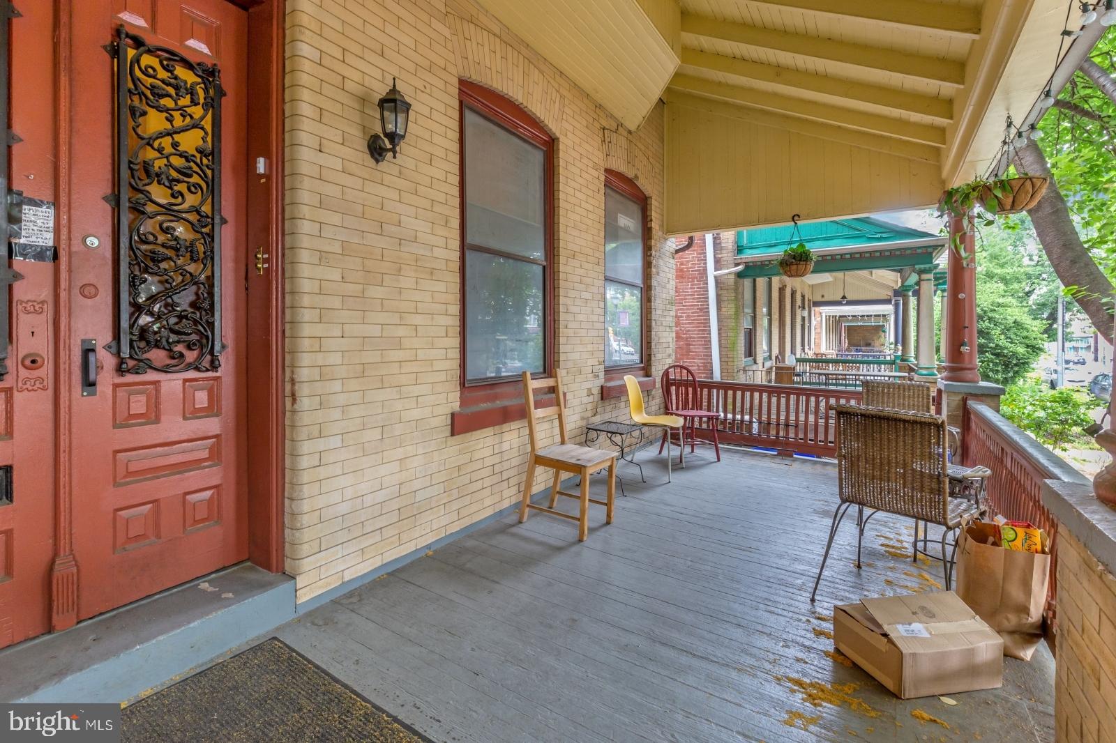 4713 Baltimore Avenue, Unit 1 Philadelphia, PA 19143 - Photo 19 of 22 a porch with a bench next to a yard