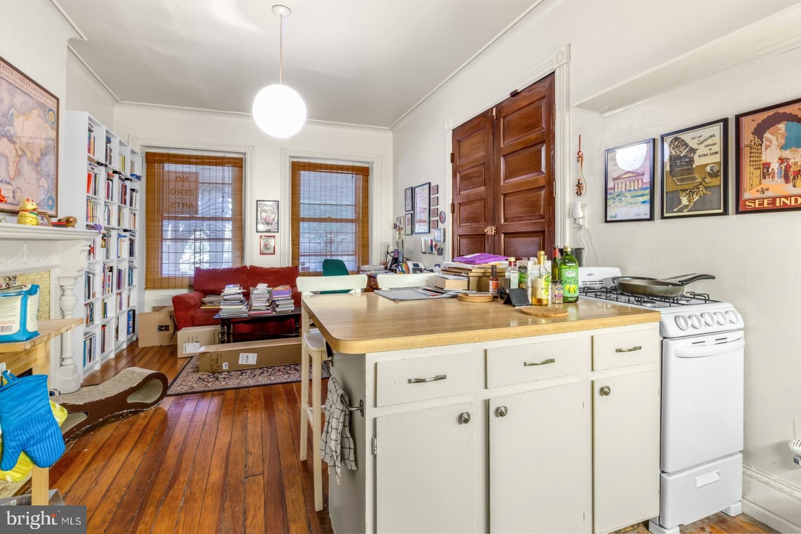 4713 Baltimore Avenue, Unit 1 Philadelphia, PA 19143 - Photo 7 of 22 a kitchen that has a lot of cabinets a sink and wooden floor