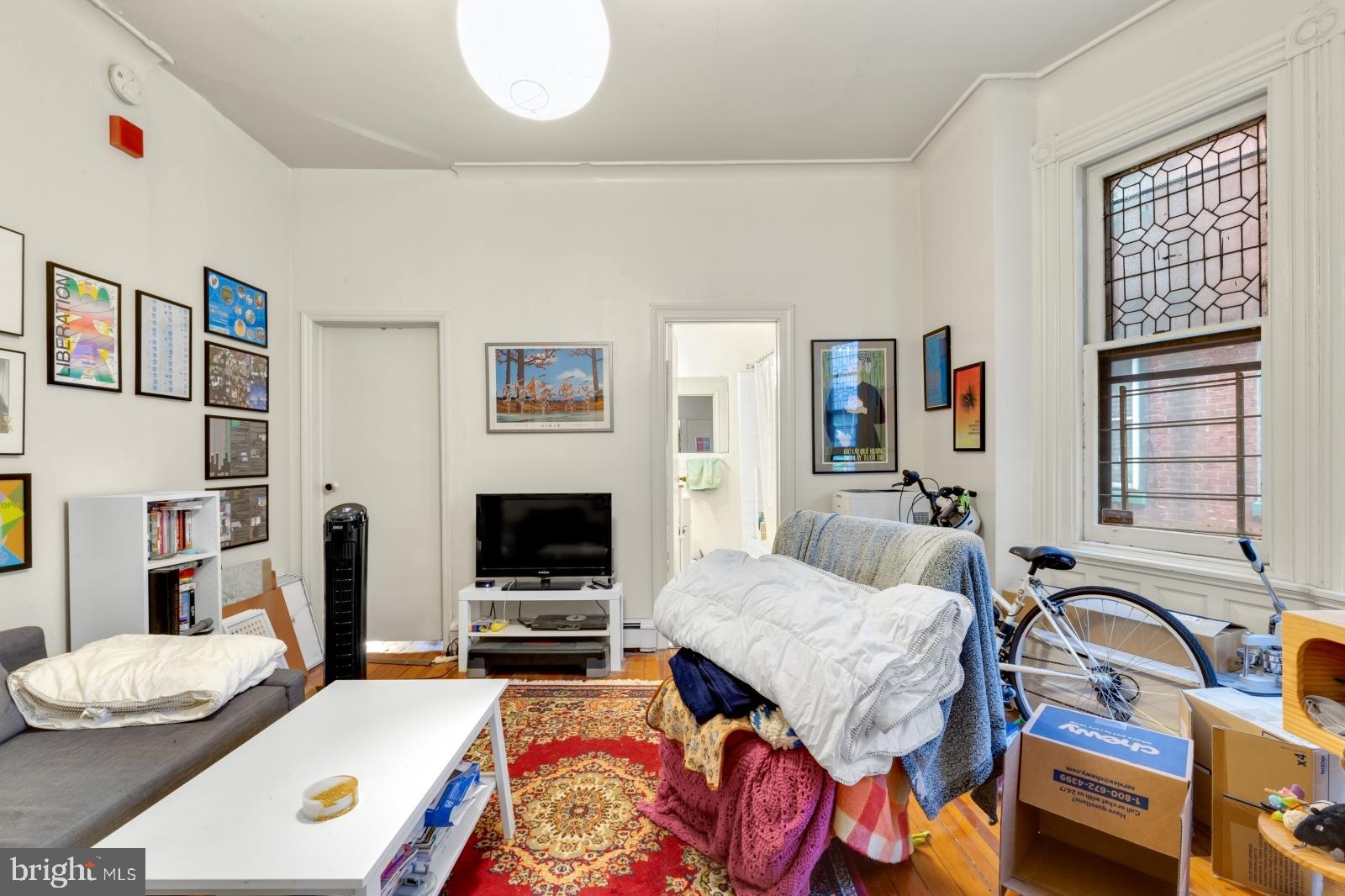 4713 Baltimore Avenue, Unit 1 Philadelphia, PA 19143 - Photo 8 of 22 a living room with furniture fireplace and flat screen tv