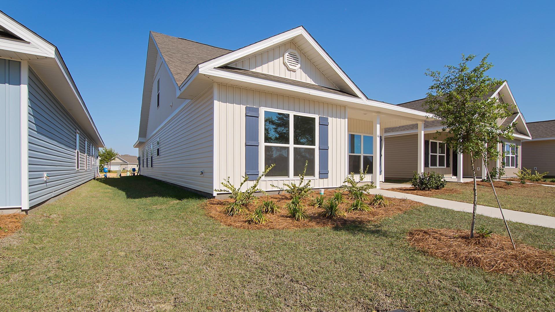73 Longsedge Street Freeport, FL 32439 - Photo 2 of 34 a front view of a house with garden