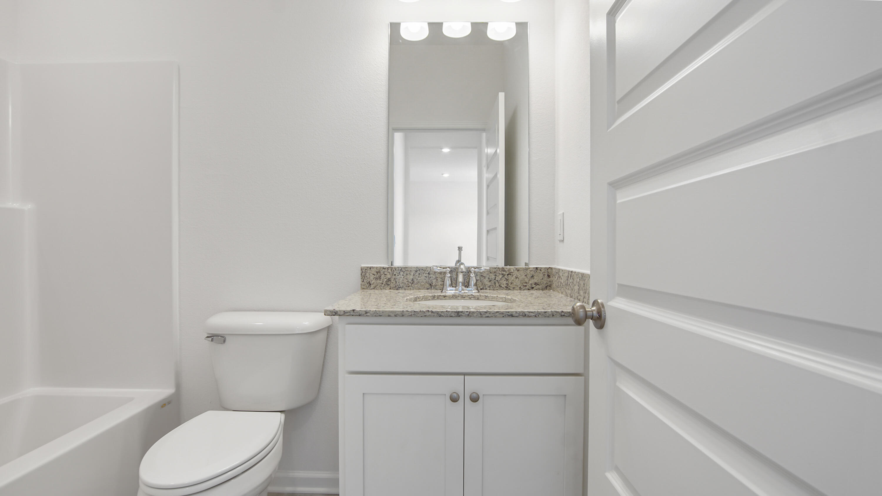 73 Longsedge Street Freeport, FL 32439 - Photo 7 of 34 a bathroom with a granite countertop toilet sink and mirror