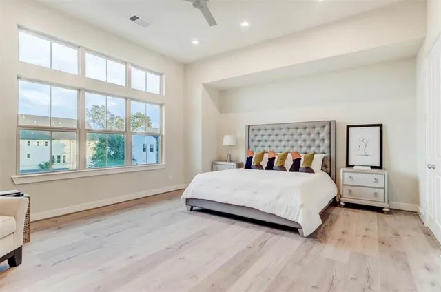 a bedroom with a large bed and a large window