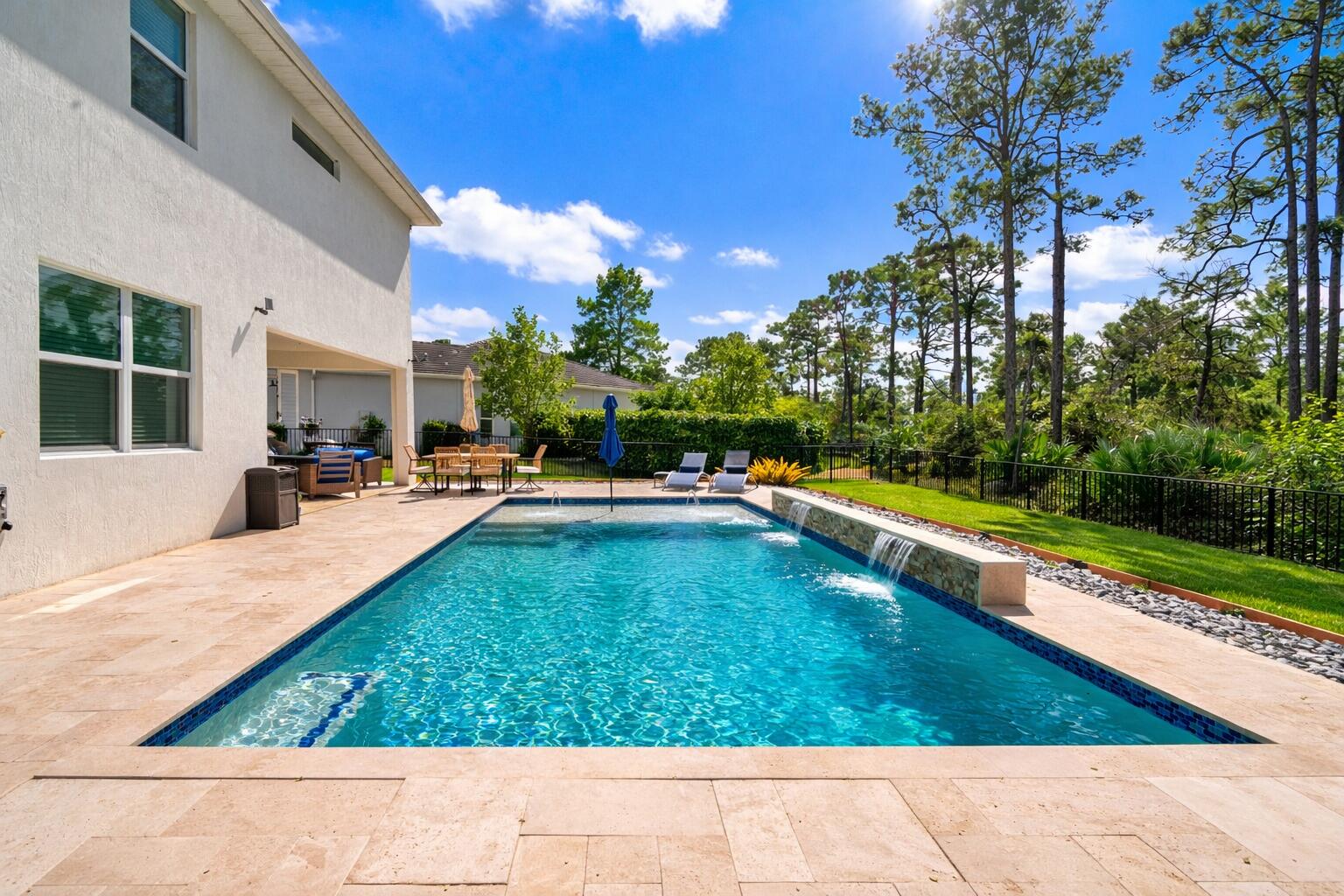 a swimming pool view with a outdoor seating