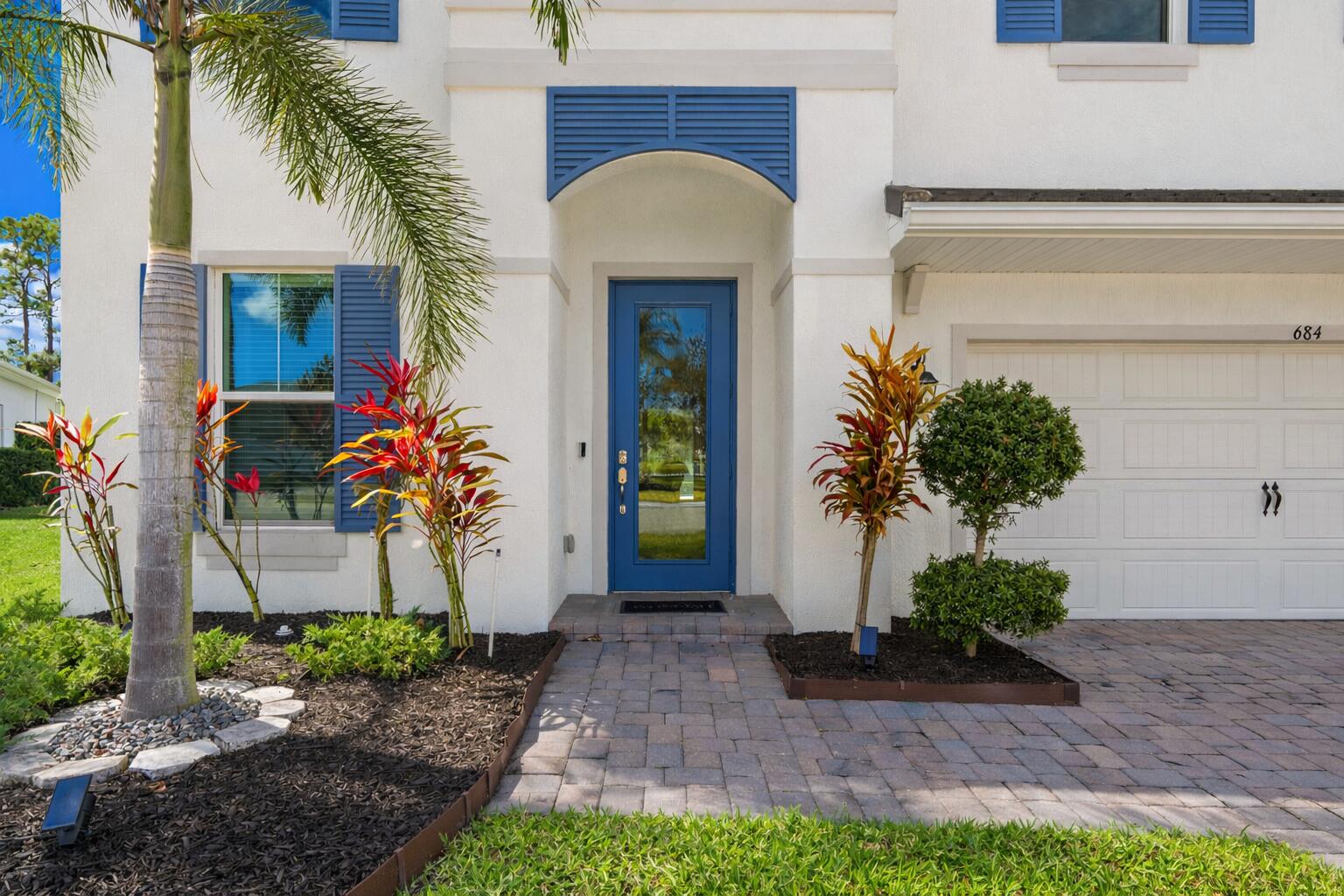 684 Southwest Pennfield Terrace Stuart, FL 34997 - Photo 2 of 61 a front view of a house with a yard