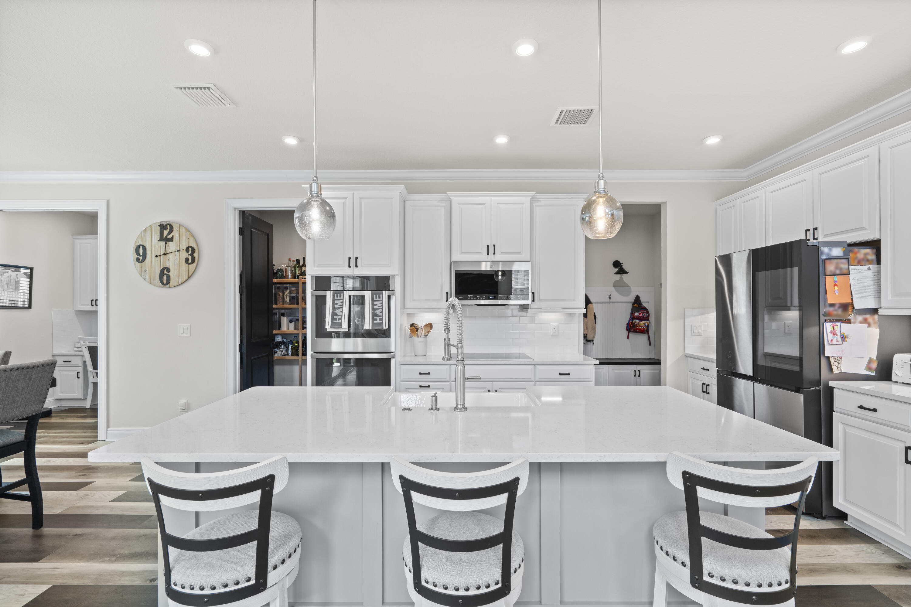 684 Southwest Pennfield Terrace Stuart, FL 34997 - Photo 2 of 61 a kitchen with a table and chairs