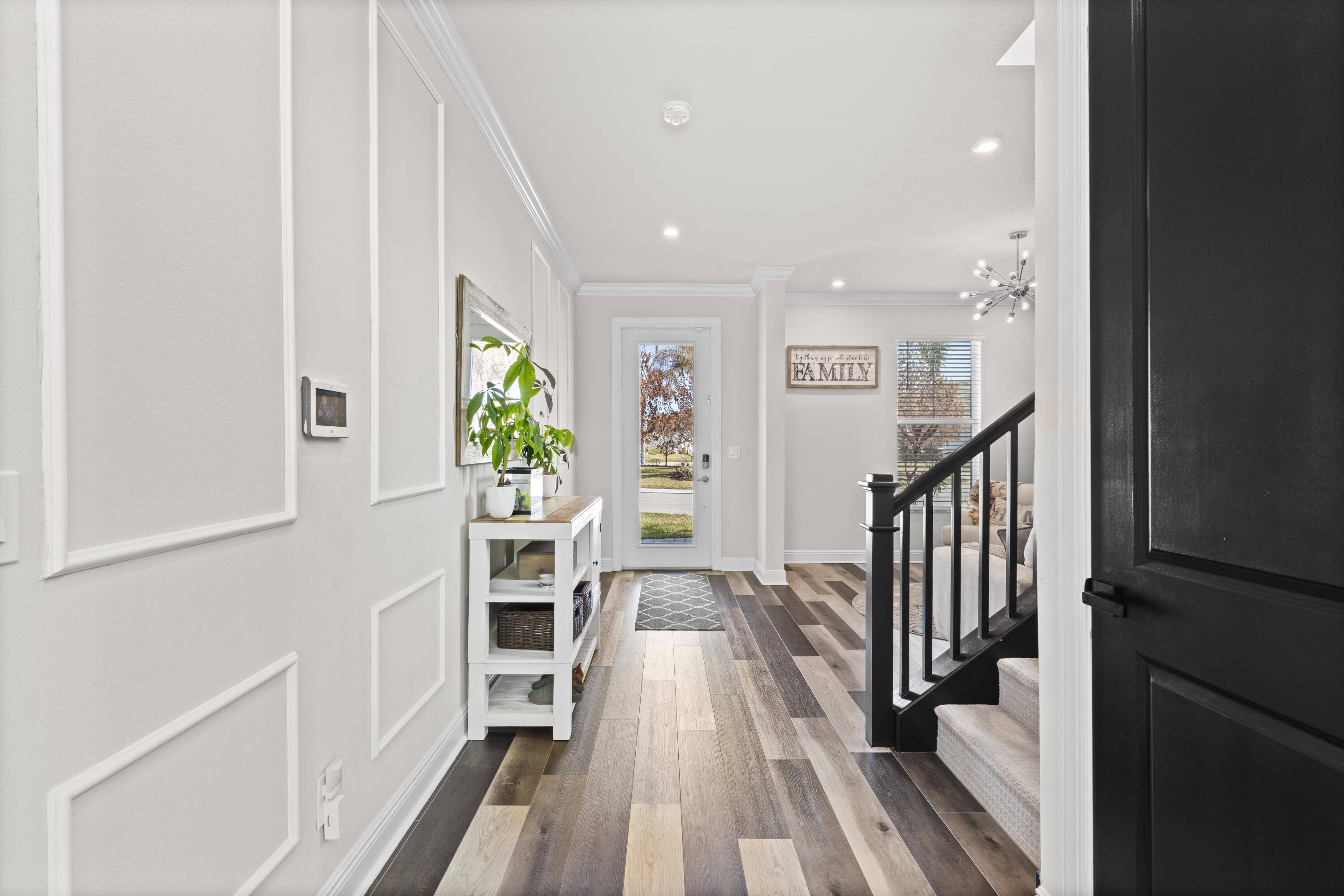684 Southwest Pennfield Terrace Stuart, FL 34997 - Photo 22 of 61 a view of a hallway with wooden floor and staircase