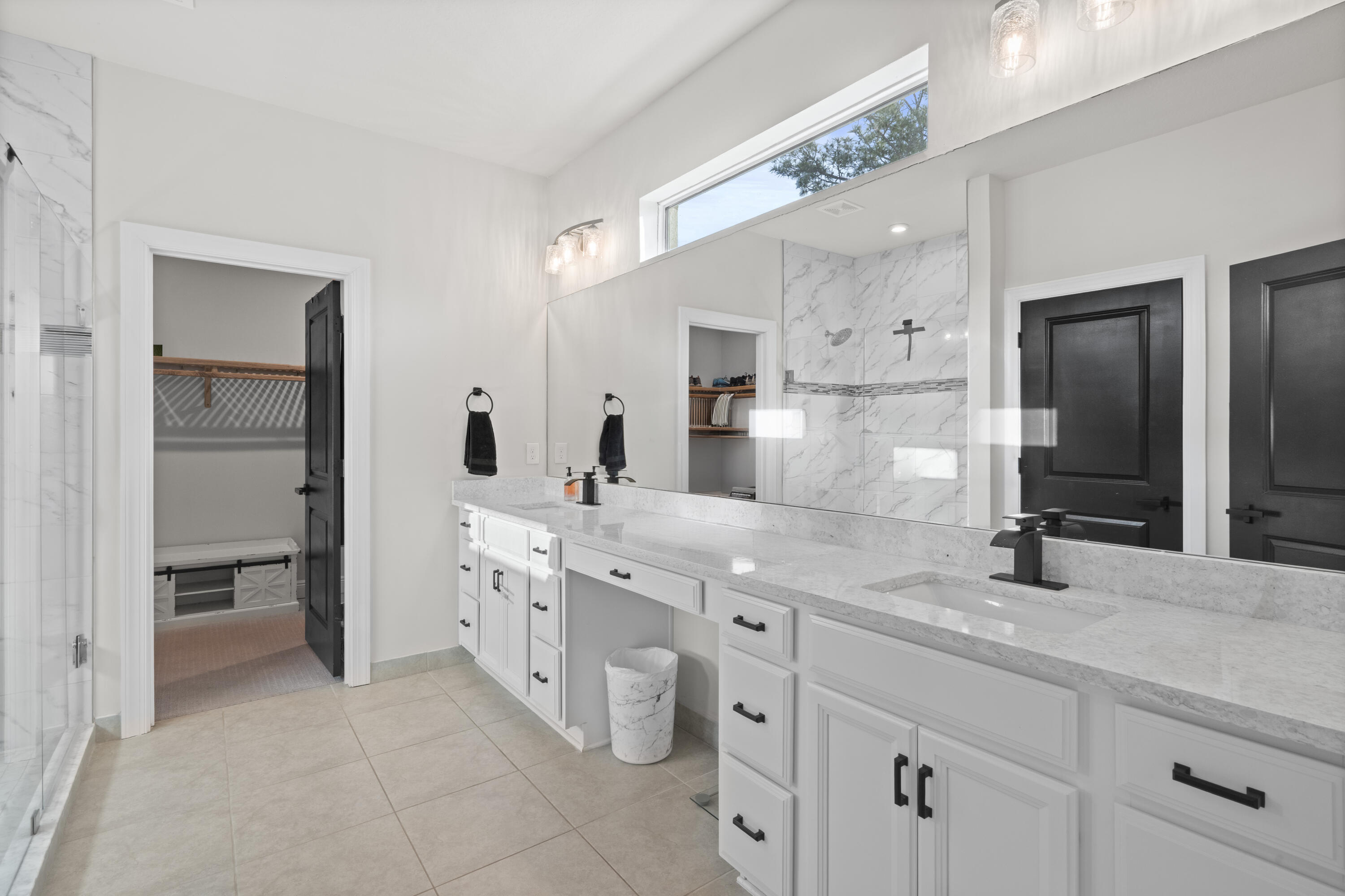 684 Southwest Pennfield Terrace Stuart, FL 34997 - Photo 26 of 61 a bathroom with a double vanity sink and a mirror
