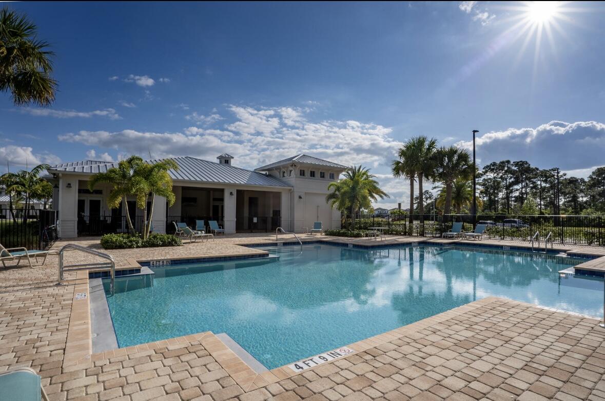 684 Southwest Pennfield Terrace Stuart, FL 34997 - Photo 49 of 61 a view of a house with pool and a garden