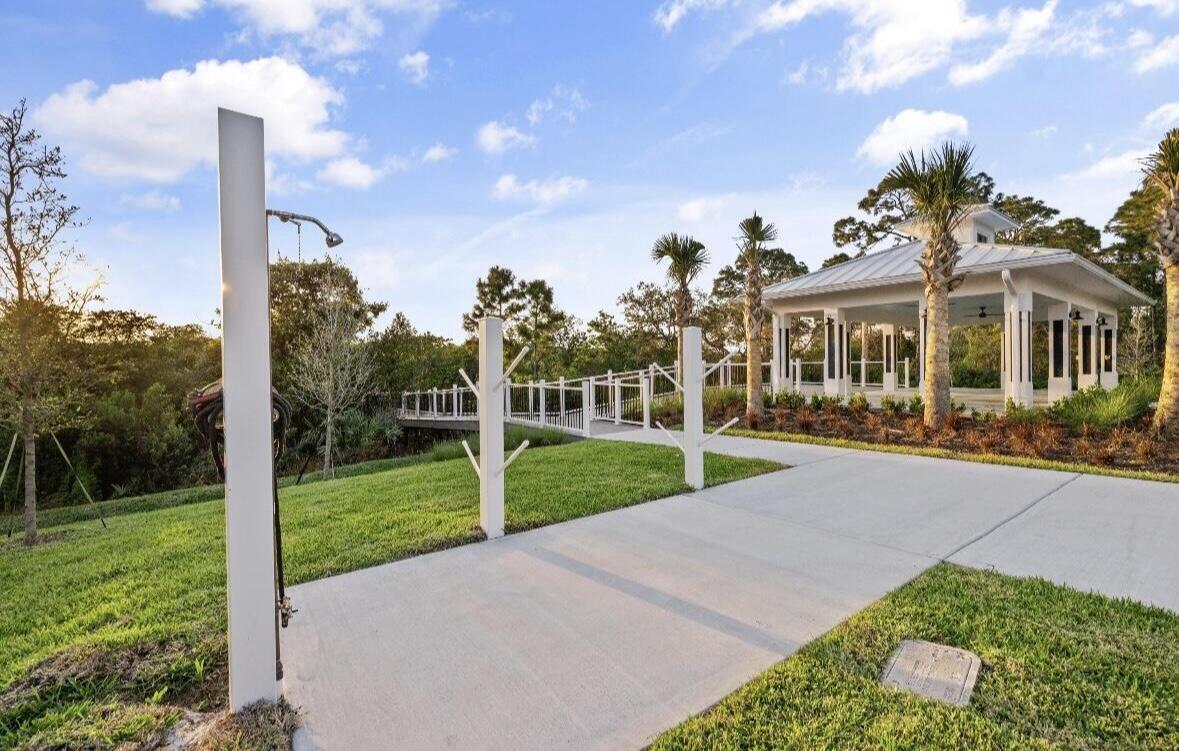 684 Southwest Pennfield Terrace Stuart, FL 34997 - Photo 50 of 61 a view of a house with a yard