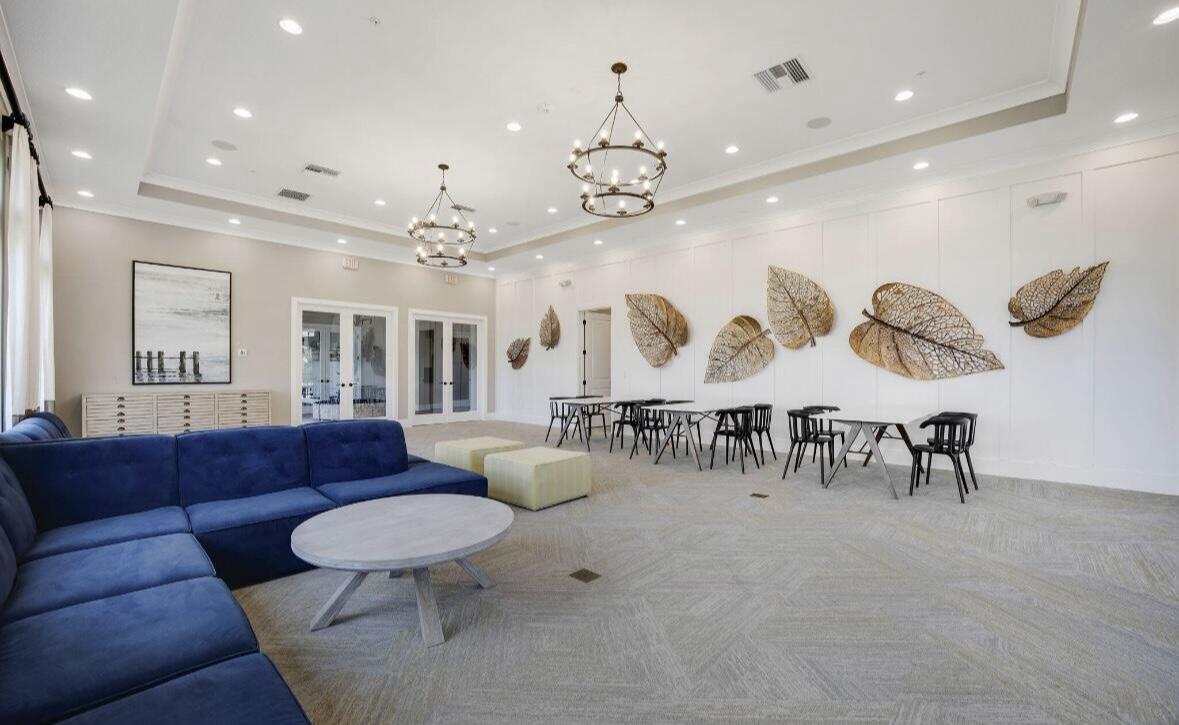 684 Southwest Pennfield Terrace Stuart, FL 34997 - Photo 59 of 61 a living room with patio furniture and a chandelier