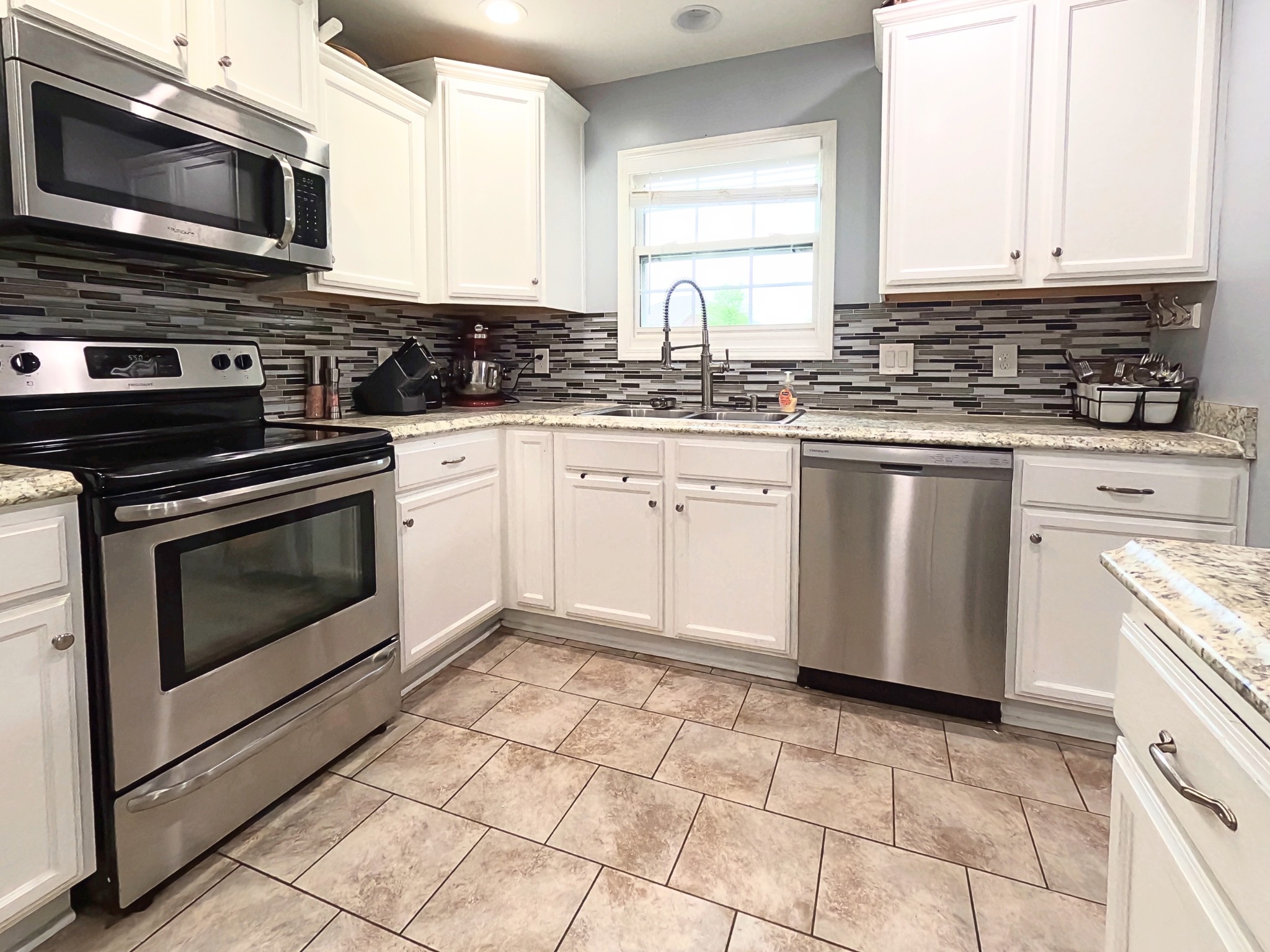 4631 Turquoise Lane Murfreesboro, TN 37129 - Photo 9 of 42 a kitchen with granite countertop a stove top oven microwave and cabinets