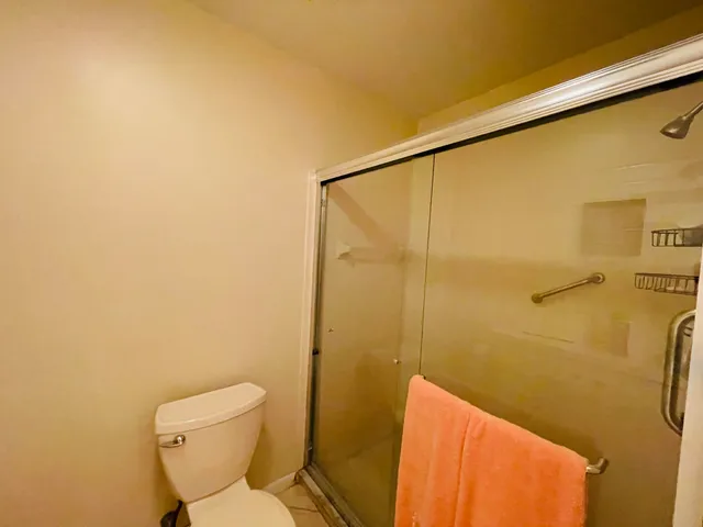 a bathroom with a toilet and shower