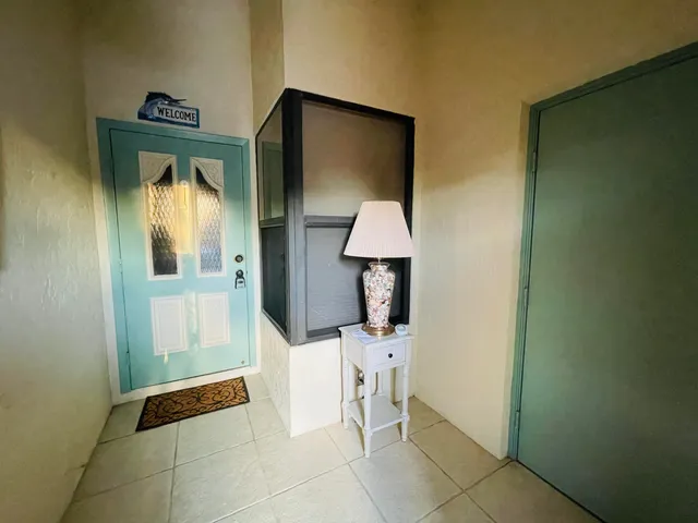 a hallway with table and closet