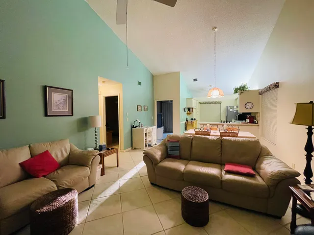 a living room with furniture a lamp and a chandelier