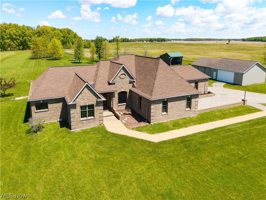 Expansive brick residence featuring a multi-gabled roofline and an arched entryway