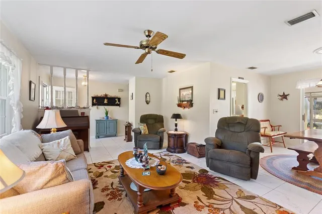 a bedroom with a bed a chair and dresser